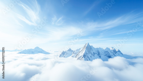 Majestic Snow-Capped Mountains Rising Above Clouds in Breathtaking Blue Sky