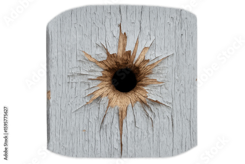 Bullet puncturing painted wooden surface, generating radial fracture pattern with splintered edges against transparent backdrop