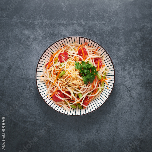  Som Tum, Green Papaya Salad on a dark concrete background. Thai Cuisine, Top View