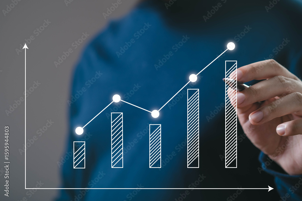 A person analyzing a growth chart with upward trends, signifying progress and success in data or business metrics. A person analyzing a growth chart with upward trends, signifying progress and success in data or business metrics.