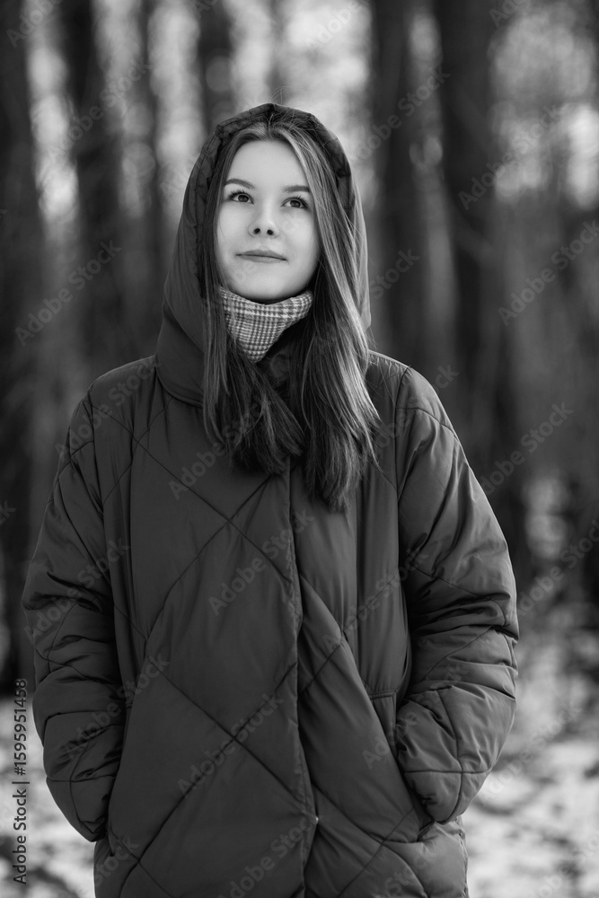 Portrait of a young beautiful long-haired girl in winter clothes outdoors. Portrait of a young beautiful long-haired girl in winter clothes outdoors.