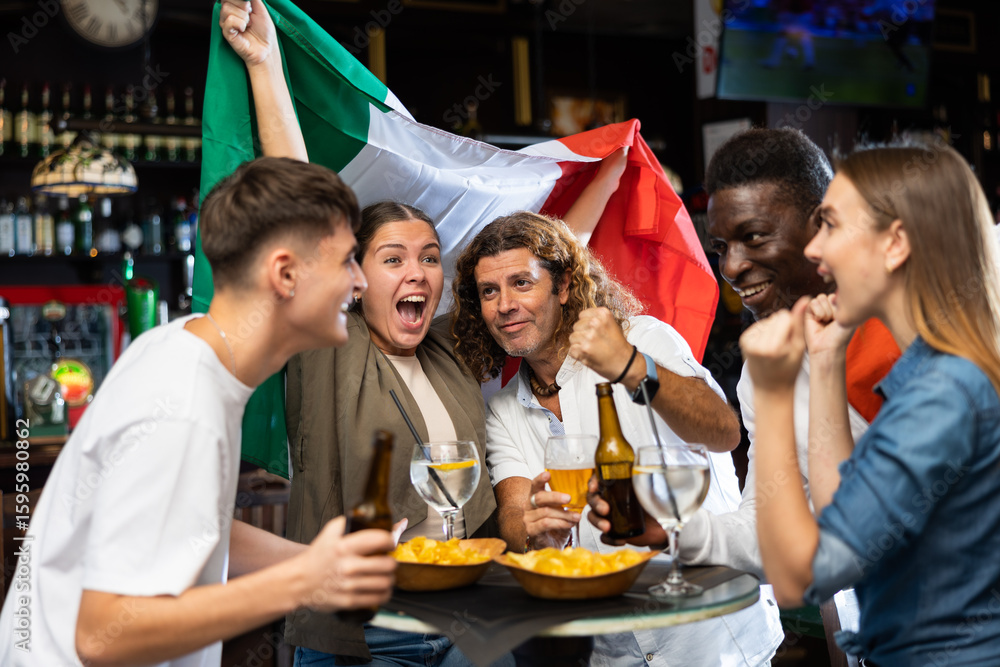Obraz premium Group of Italy football team fans spending time in bar, drinking bear and having fun. People with state flag in pub.