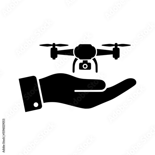 A black vector icon showing a modern quadcopter drone with a camera hovering over an open human hand on a white background.