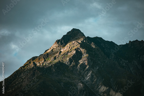 Sunshine on a mountain peak surrounded by clouds
