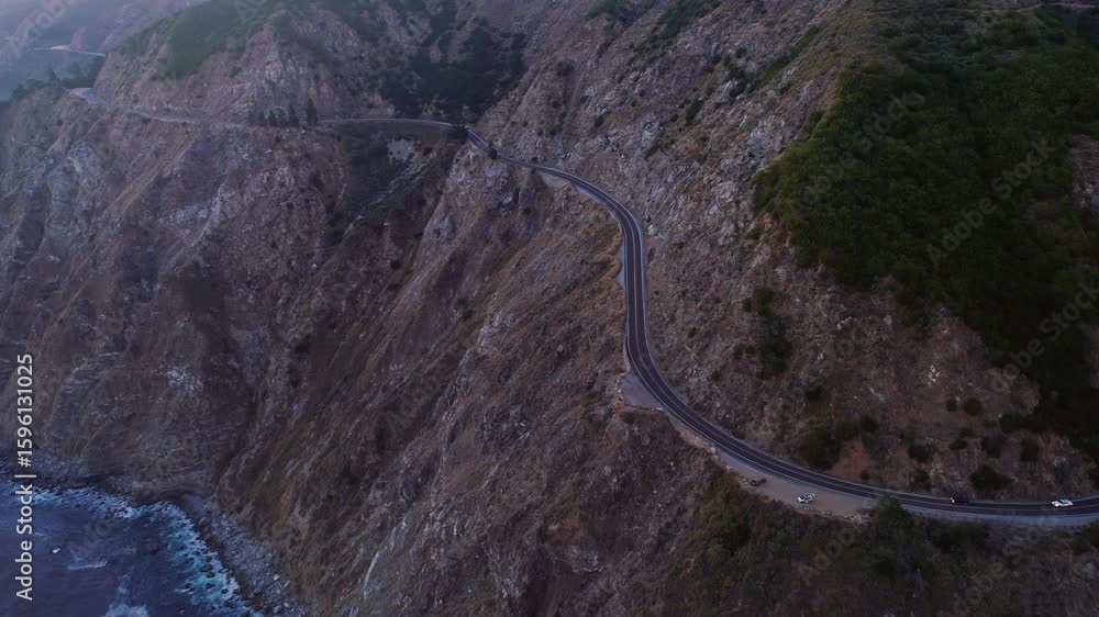 Aerial view of Highway 1 winding along the rugged California coastline ...