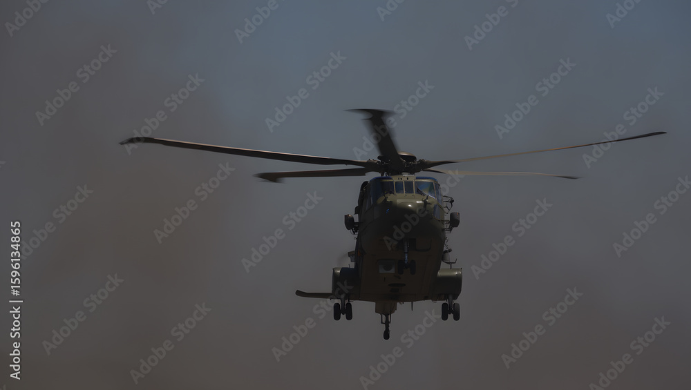 Fototapeta premium Military Helicopter in Flight, Dramatic Low-Angle Shot, Haze Background, Powerful, Serious Mood.