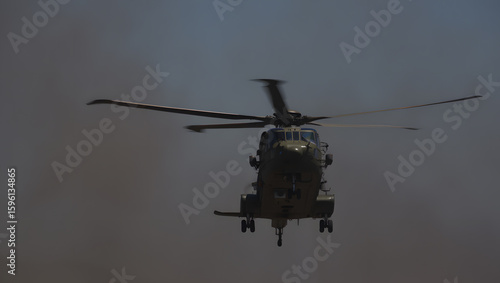 Wallpaper Mural Military Helicopter in Flight, Dramatic Low-Angle Shot, Haze Background, Powerful, Serious Mood. Torontodigital.ca
