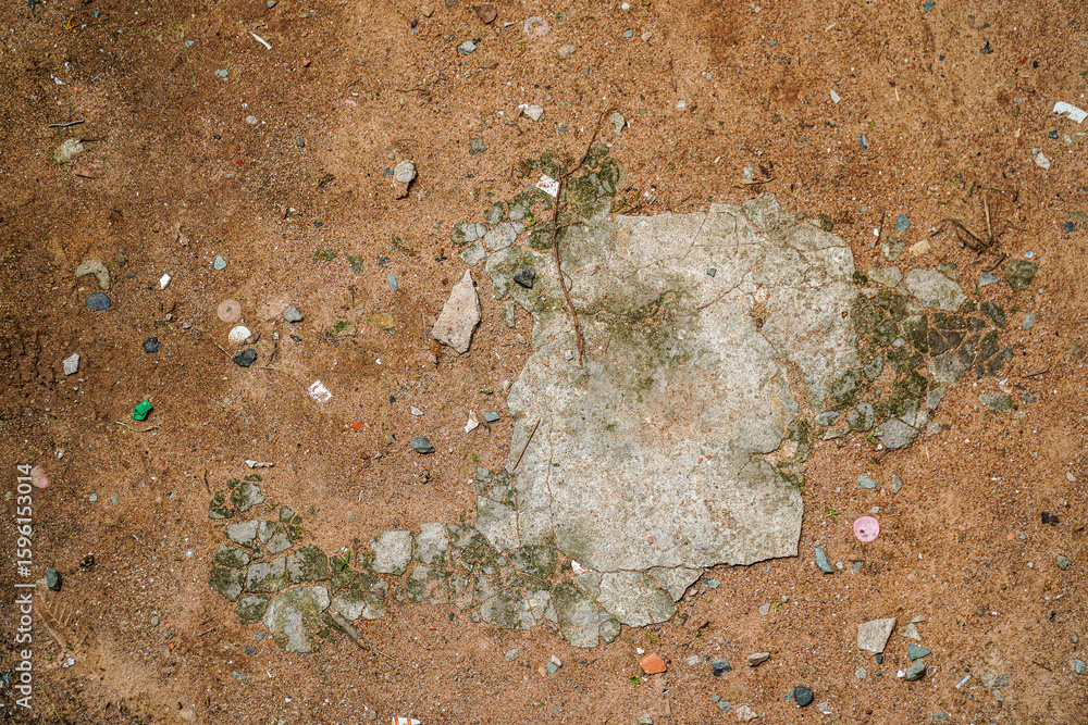 Ταπετσαρία An overhead shot reveals an abstract textured surface, a blend of coarse sand and deteriorating concrete, creating a rich contrast suitable for backgrounds and textures in designs and photography