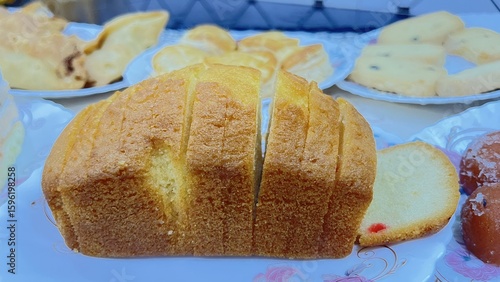 Wallpaper Mural Artisanal Bread Display – Sliced Loaf and Sweet Pastries on Rustic Tabletop Torontodigital.ca
