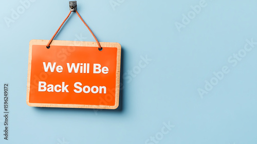 Business temporarily closed. An orange sign on a blue wall indicates a business is taking a short break. 