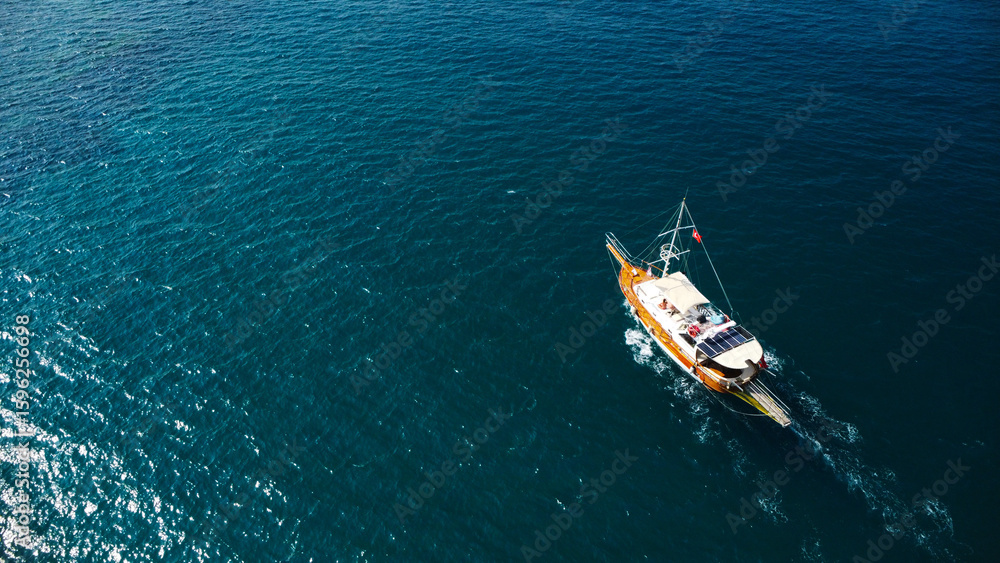 Fototapeta premium Aerial View of a Touristic Boat on Deep Blue Sea