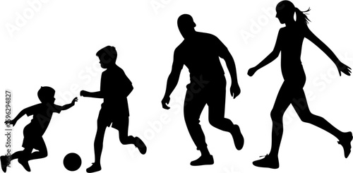Silhouettes of a family playing soccer together in a park on a sunny day having fun and exercising