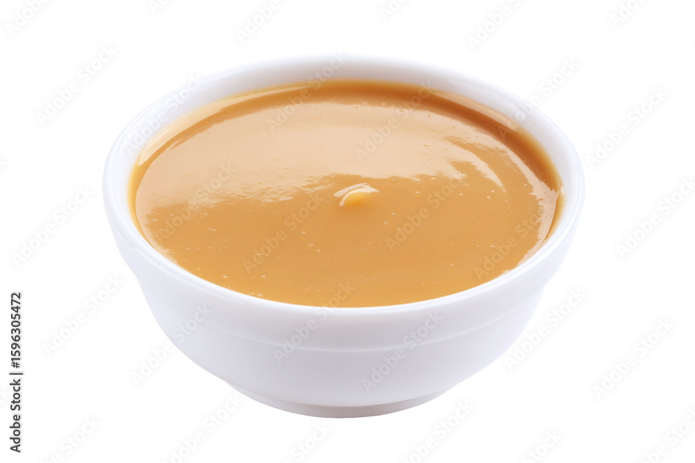 Bowl of creamy caramel sauce isolated on white transparent background Bowl of creamy caramel sauce isolated on white transparent background