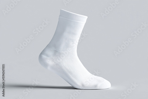 A single white sock displayed against a minimalist backdrop. The sock is pristine and neatly shaped, showcasing its design and material