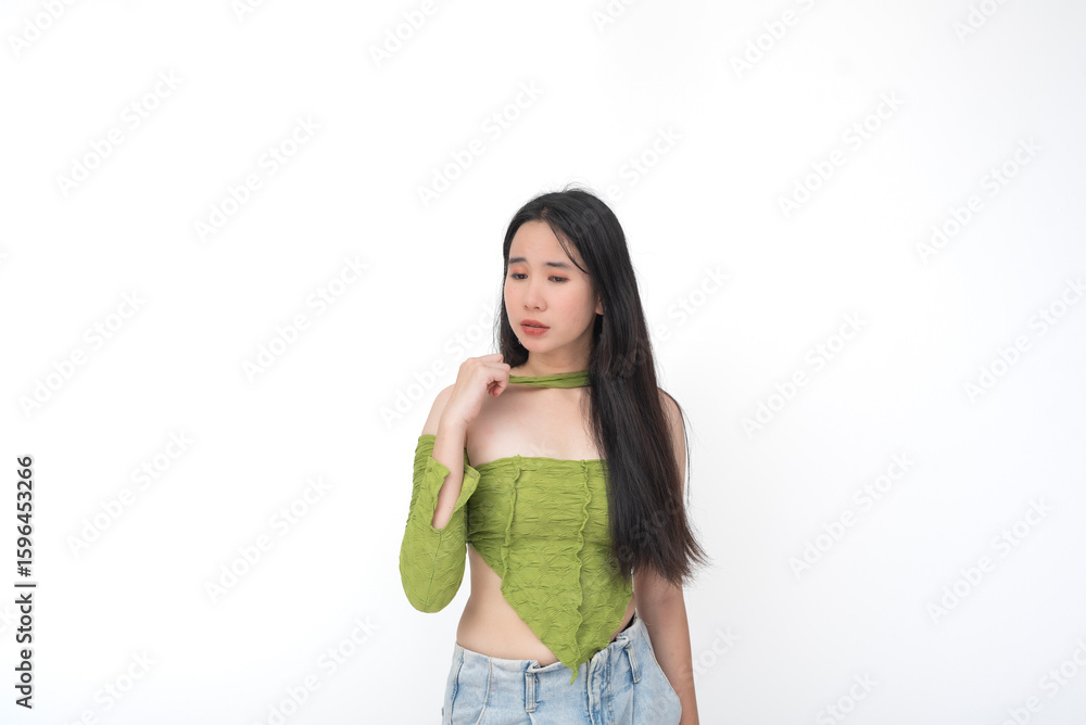 Worried young Asian woman looking down in sadness Worried young Asian woman looking down in sadness