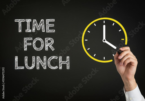 Chalkboard drawing of a clock indicating time for lunch