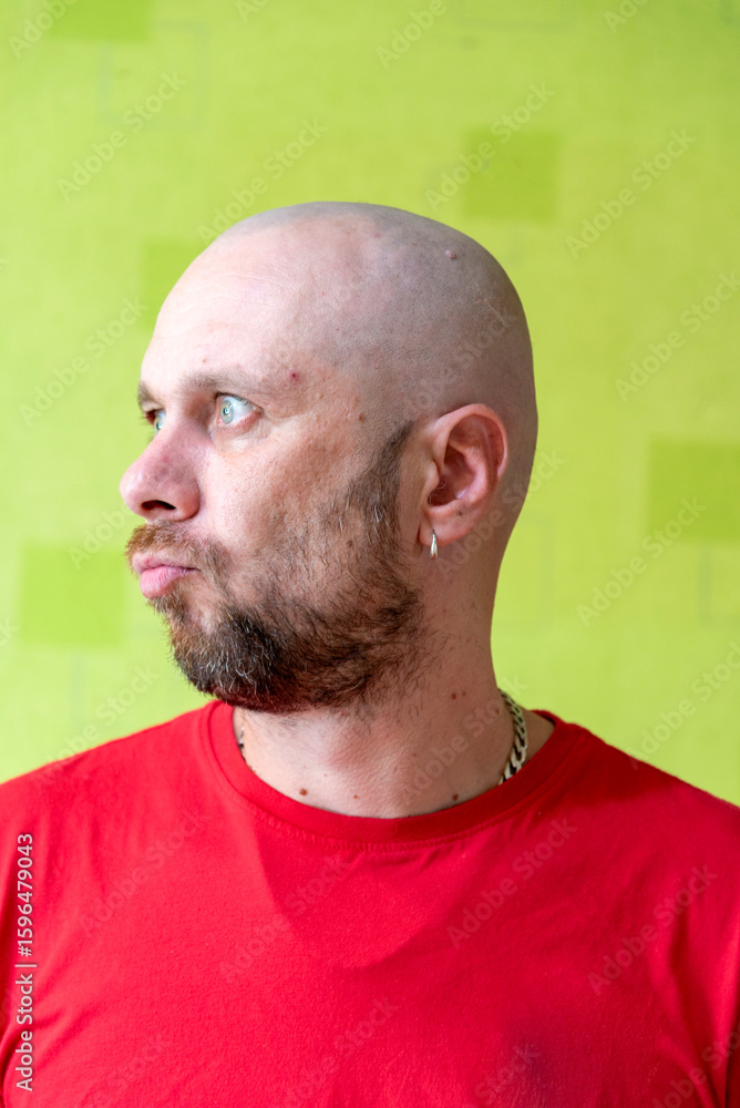 Fototapeta premium A man poses against a wall, making various grimaces