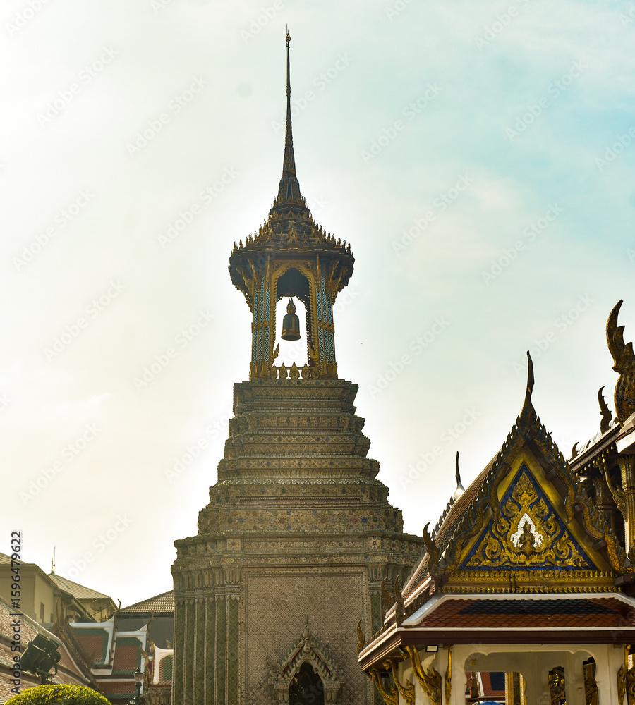 Fototapeta premium Traditional Thai temple spire and bell tower, embodying exquisite cultural architecture under a clear sky.