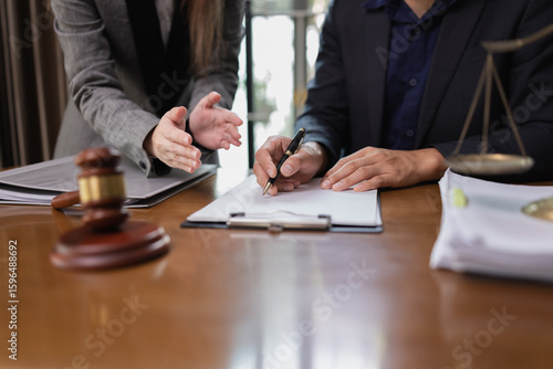 Two Lawyer with Document Paper and Hammer on Wood table,  Judge's Gavel, Law, Justice Symbol, Agreement and Partnership Concept,