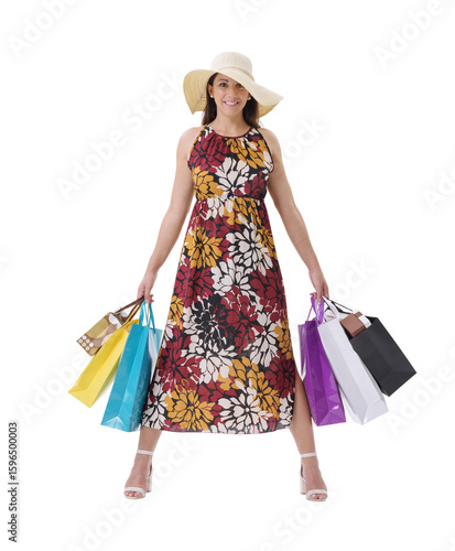 A beautiful, smiling young woman posing with lots of shopping bags, standing against a white background.