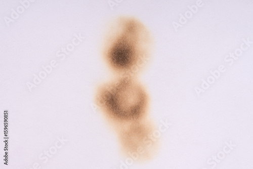 Paper burn black  stain. Round paper burn mark close up. burns borders paper close up