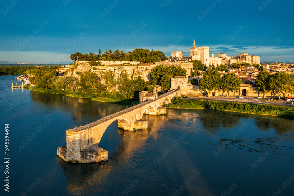 Naklejka premium Beautiful view of Avignon with famous bridge Saint-Benezet, medieval architecture along the Rhone River in Avignon, France. The Pont Saint Benezet and the Papal palace in Avignon, South France.
