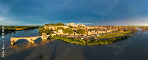Beautiful view of Avignon with famous bridge Saint-Benezet, medieval architecture along the Rhone River in Avignon, France. The Pont Saint Benezet and the Papal palace in Avignon, South France.