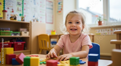 Smiling child playing with wooden blocks