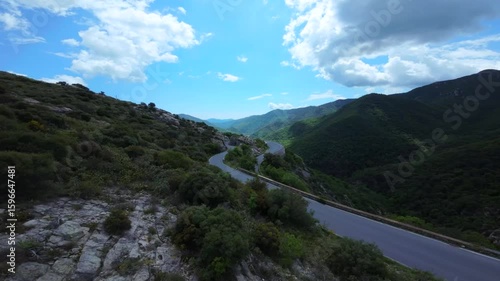 Drone view of serpentine asphalt road in mountainous area in Italian Alps. cars are going on a trip. Green planet. Tourism. Transport. Dangerous road. Italy Bergamo 20.08.2025