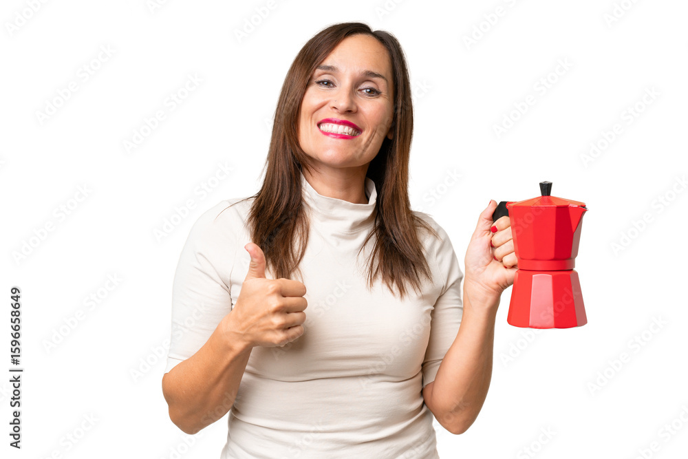 Middle-aged caucasian woman holding coffee pot over isolated background with thumbs up because something good has happened Middle-aged caucasian woman holding coffee pot over isolated background with thumbs up because something good has happened