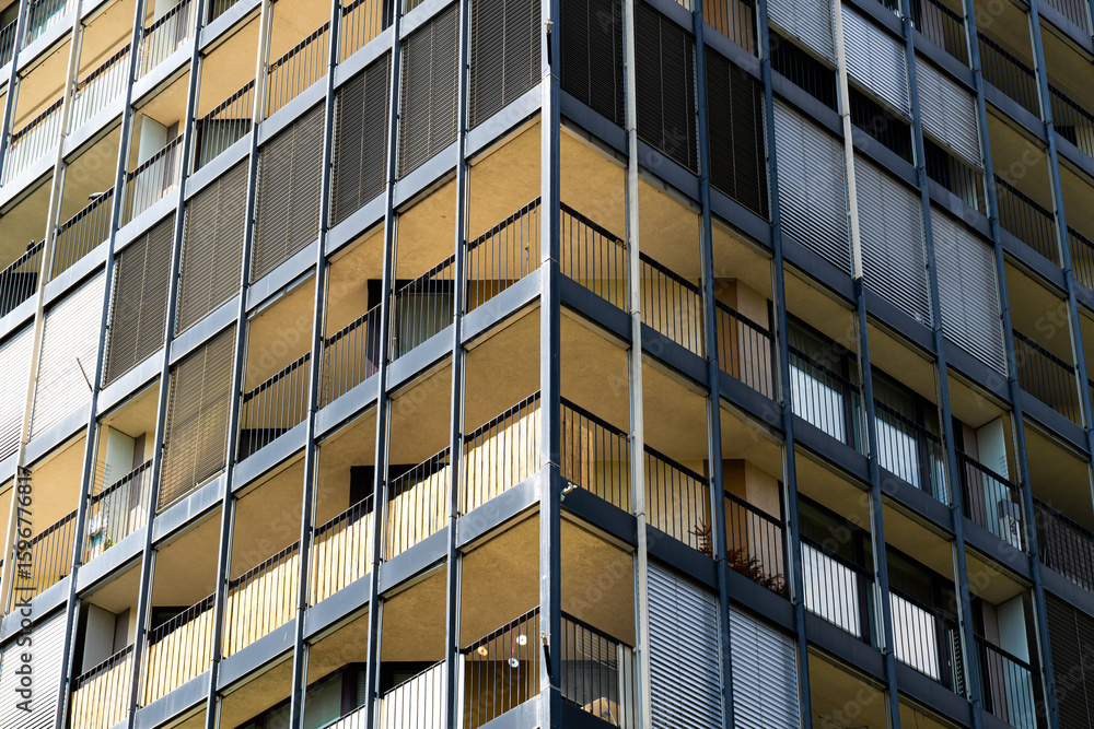 Residential tower with deep balconies and a grid of glass and concrete Residential tower with deep balconies and a grid of glass and concrete