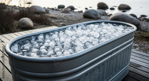 Galvanized tub full of ice cubes for refreshing outdoor bath