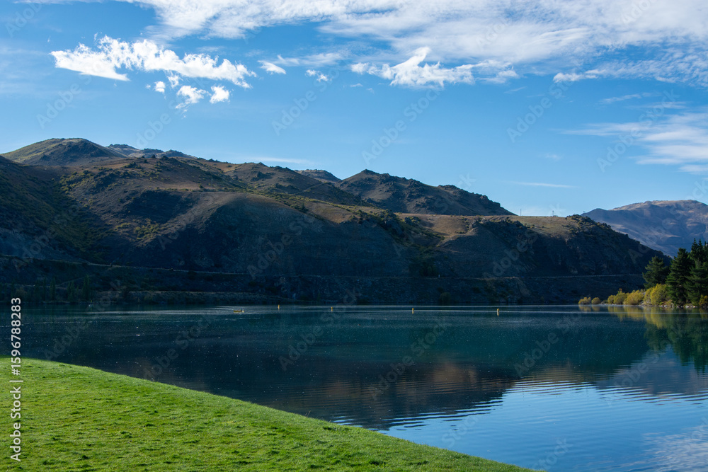 Serene Lake Landscape with Mountains and Blue Sky Serene Lake Landscape with Mountains and Blue Sky