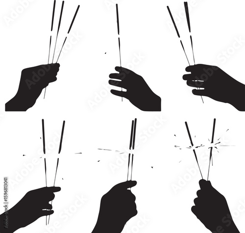Black silhouette hands holding sparklers fireworks
