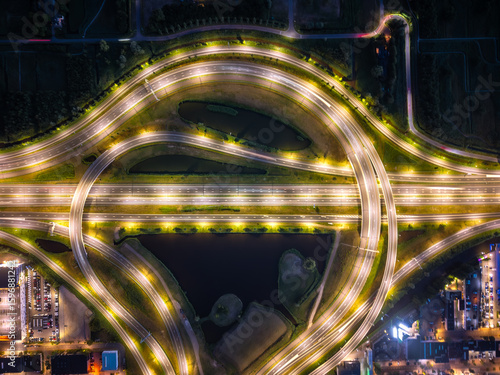 Принти на полотні Aerial view of illuminated cloverleaf interchange over canals at night