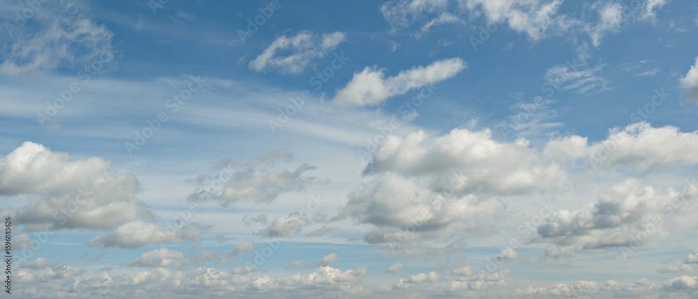 Fototapeta premium heaven sky is blue with many clouds. clouds are scattered throughout the sky and are of various sizes.