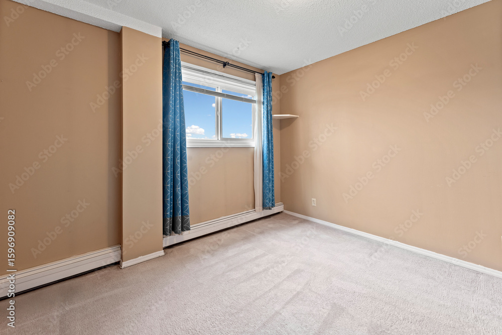 Fototapeta premium Room with a blue curtain and a window