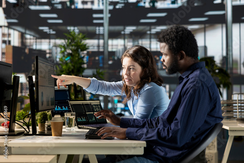 Diverse business associates working together to finalize a strategic plan for organizational growth, looking for solutions and increase funding. Work team collaborate on development.