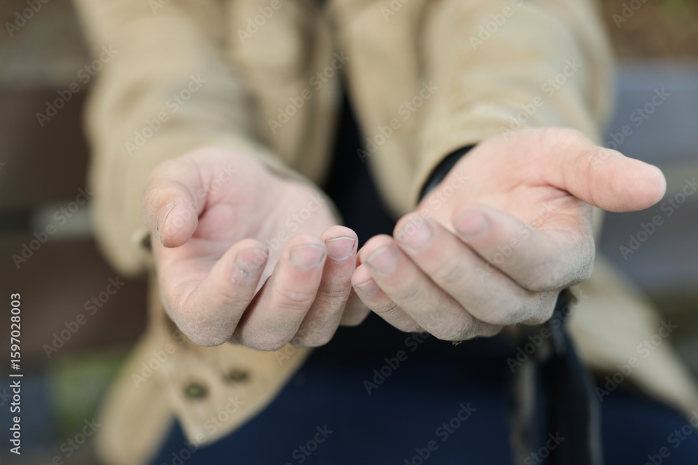 Homeless man begging for money outdoors, selective focus Homeless man begging for money outdoors, selective focus