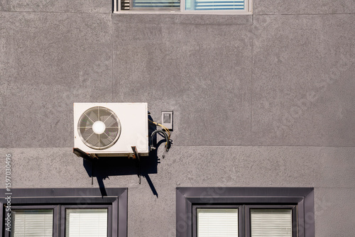 Photography mini split air conditioner / heat pump exterior unit monuted on the brick wall o