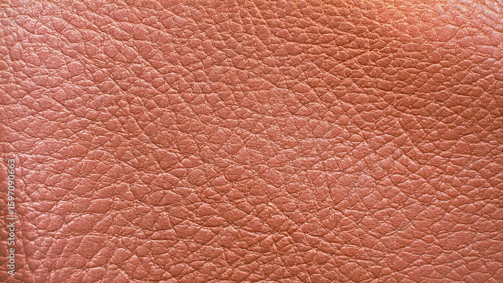 Fototapeta premium Textured leather fills the frame. Surface is rough, shiny, and pink. Good for design, backgrounds, marketing, banners, and editorial use.