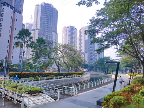 Wallpaper Mural View of Jakarta's public park in the morning with a clean river and modern buildings in the background Torontodigital.ca