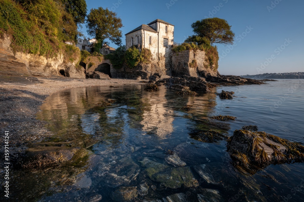 Coastal house reflected in calm waters Coastal house reflected in calm waters