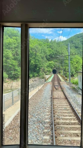 Railway track in the middle of forest in the mountain.  Train railroad in the rural area in South Korea