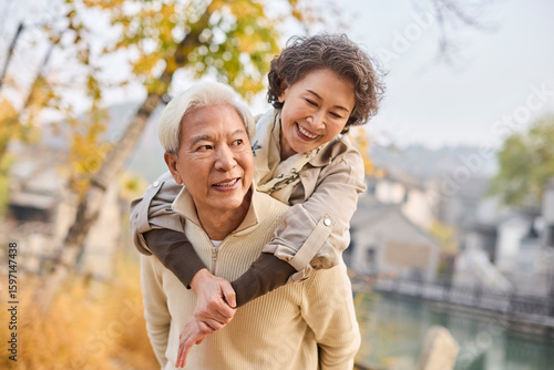 Senior couple exploring the charm of a man-made ancient town scenic spot