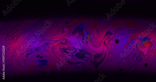 Neon oil mix. Spectrum soap. Purple red blue color paint wave curl liquid. Gradient gasoline floating abstract blur black background.