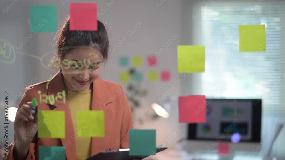Southeast asian businesswoman brainstorming using sticky notes Southeast asian businesswoman brainstorming using sticky notes
