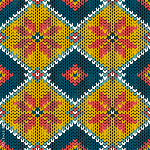 Vibrant knitted pattern featuring large yellow diamond shapes with red floral motifs on a navy background. Perfect for cozy textiles, handmade crafts, and vintage-inspired creative designs.