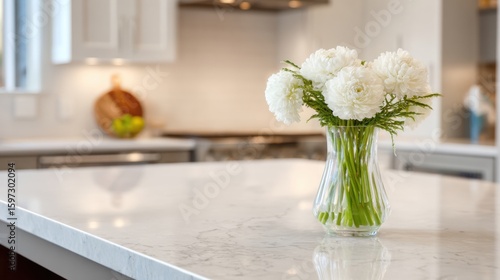 Wallpaper Mural A clear glass vase holds fresh white flowers, adorned with greenery, placed on a sleek marble countertop in a bright, modern kitchen setting. Natural light filters in, enhancing the serene atmosphere. Torontodigital.ca