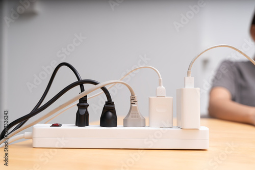 Wallpaper Mural Power strip with multiple plugs and cables connected on wooden table, electricity and energy supply concept Torontodigital.ca
